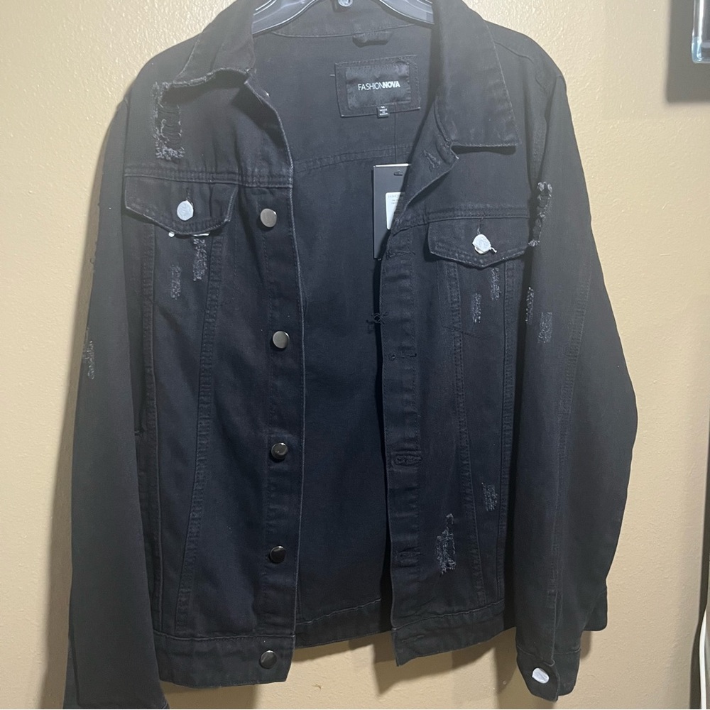 New black denim jacket with tiger print on the back, ready to wear.